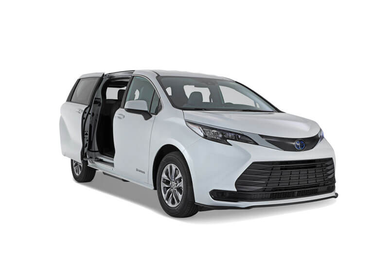 A white Toyota Sienna Hybrid minivan with its rear passenger sliding door open, viewed from the front left side, against a plain white background.